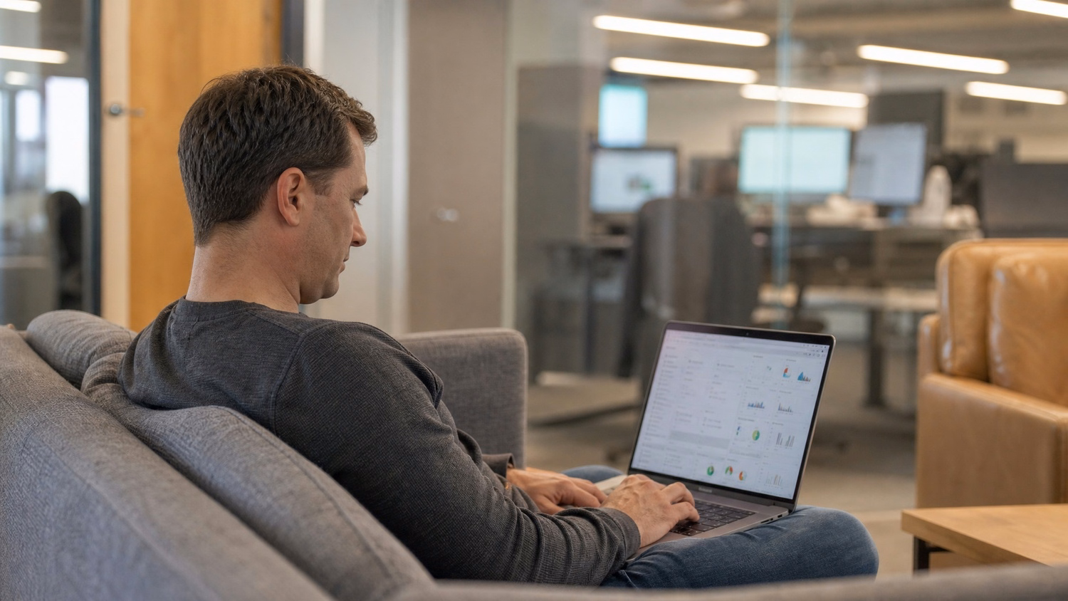 LOUNGE AREA LAPTOP An IT professional one person working on a laptop in a ca
