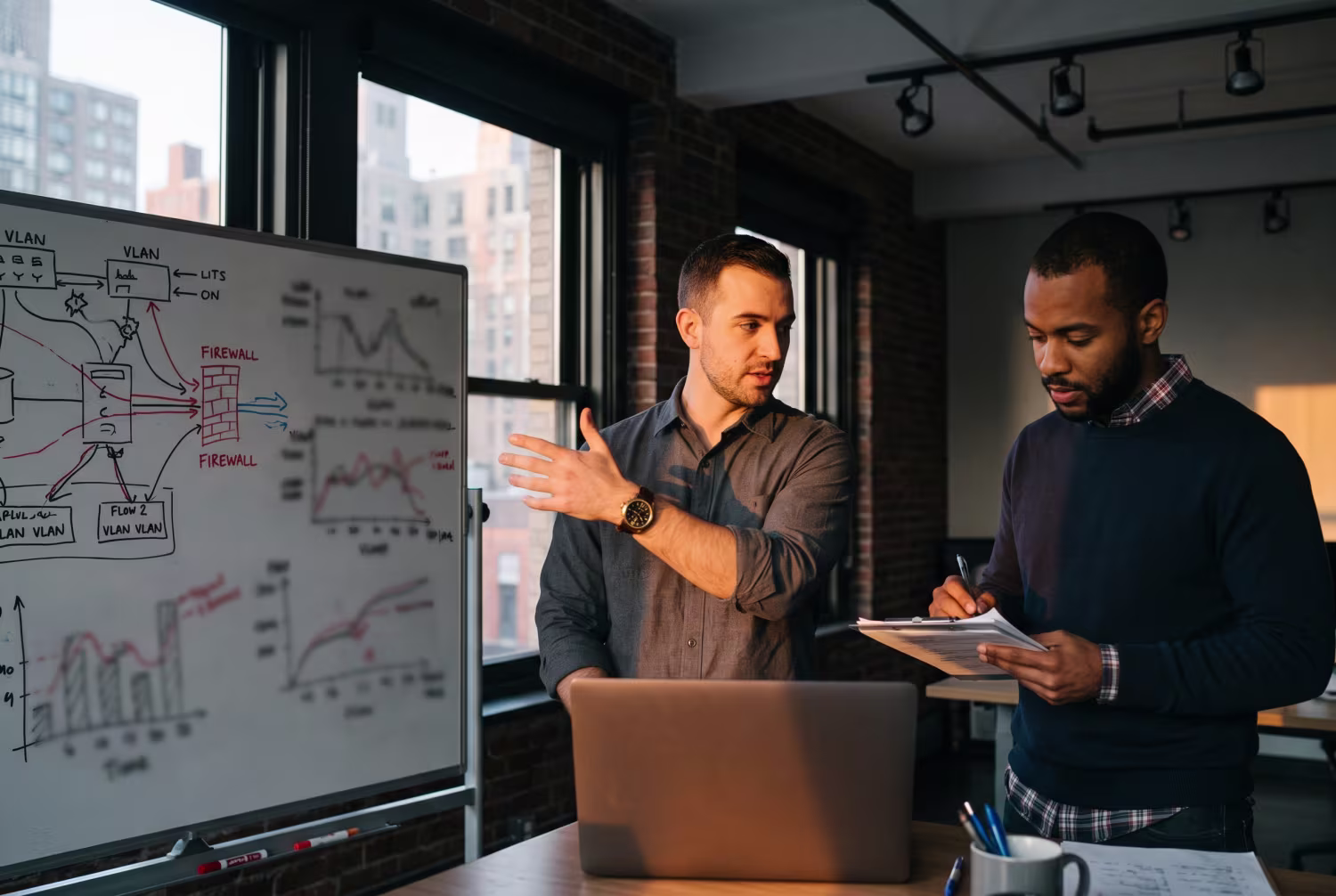 Two IT consultants discussing business IT network improvements