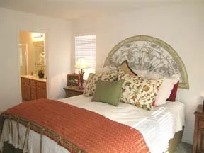 furnished bedroom with bed and view of bathroom