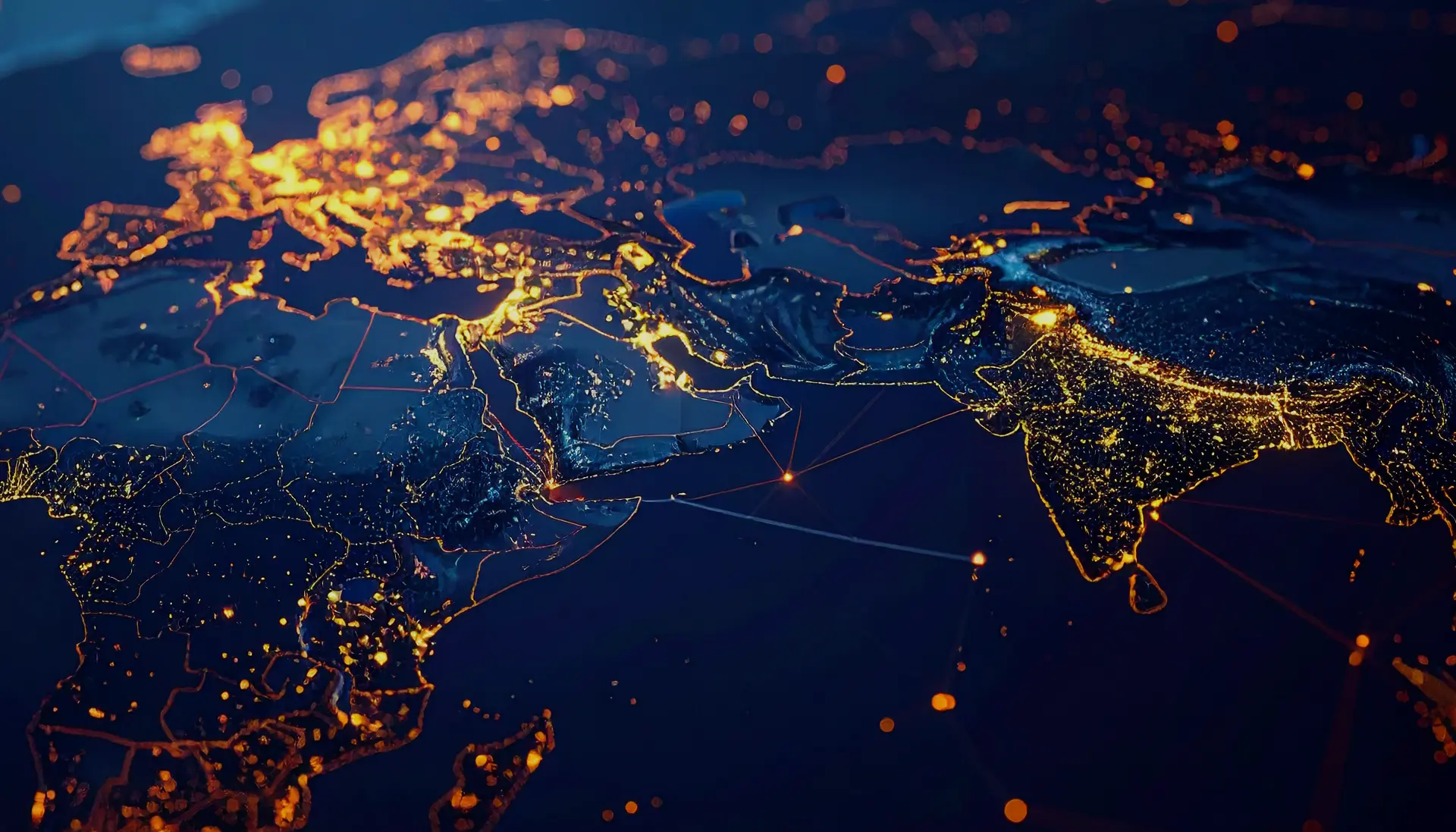 Nighttime satellite view of Europe, the Middle East, and India showing illuminated cities and connecting network lines.