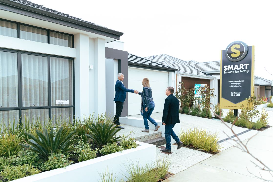 Home buyers outside a home for sale