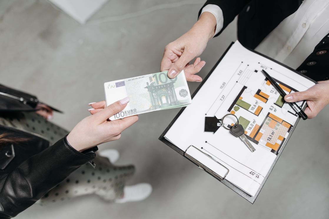 property manager handing the key and floorplan of the house back to the owner
