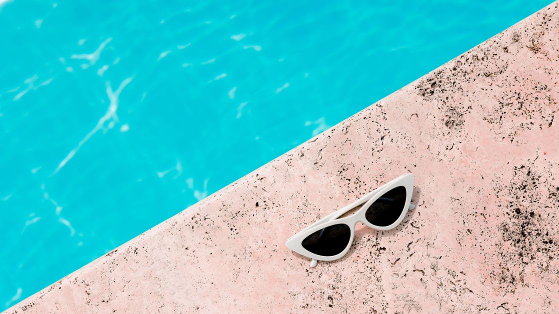 sunglasses beside a pool during summer