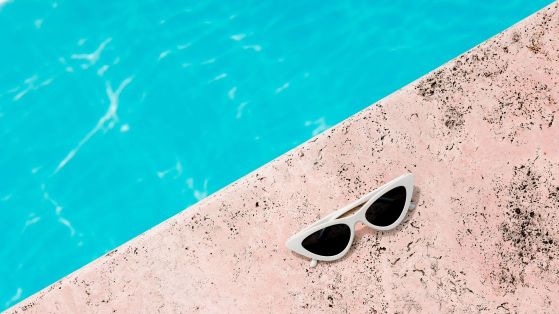 sunglasses beside a pool during summer