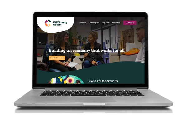 Laptop showing a website for Center for Community Wealth with people talking and text about building an inclusive economy.