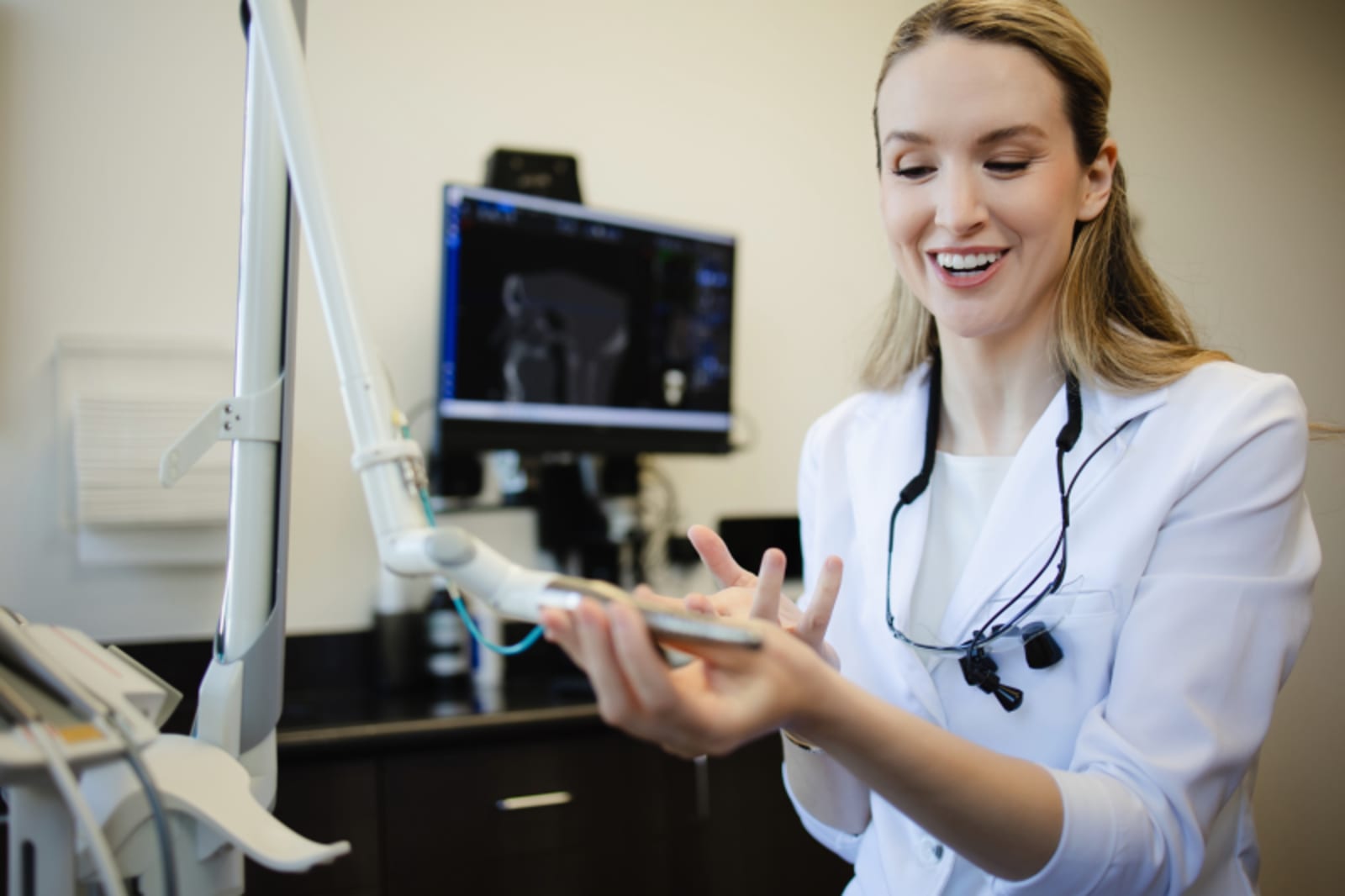 Dentist holding dental model and pointing during patient consultation