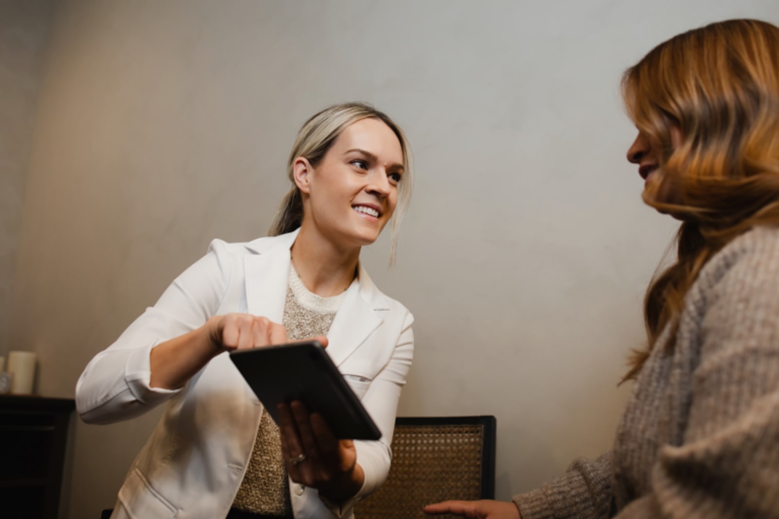 Dentist greeting patient with handshake in dental office reception area