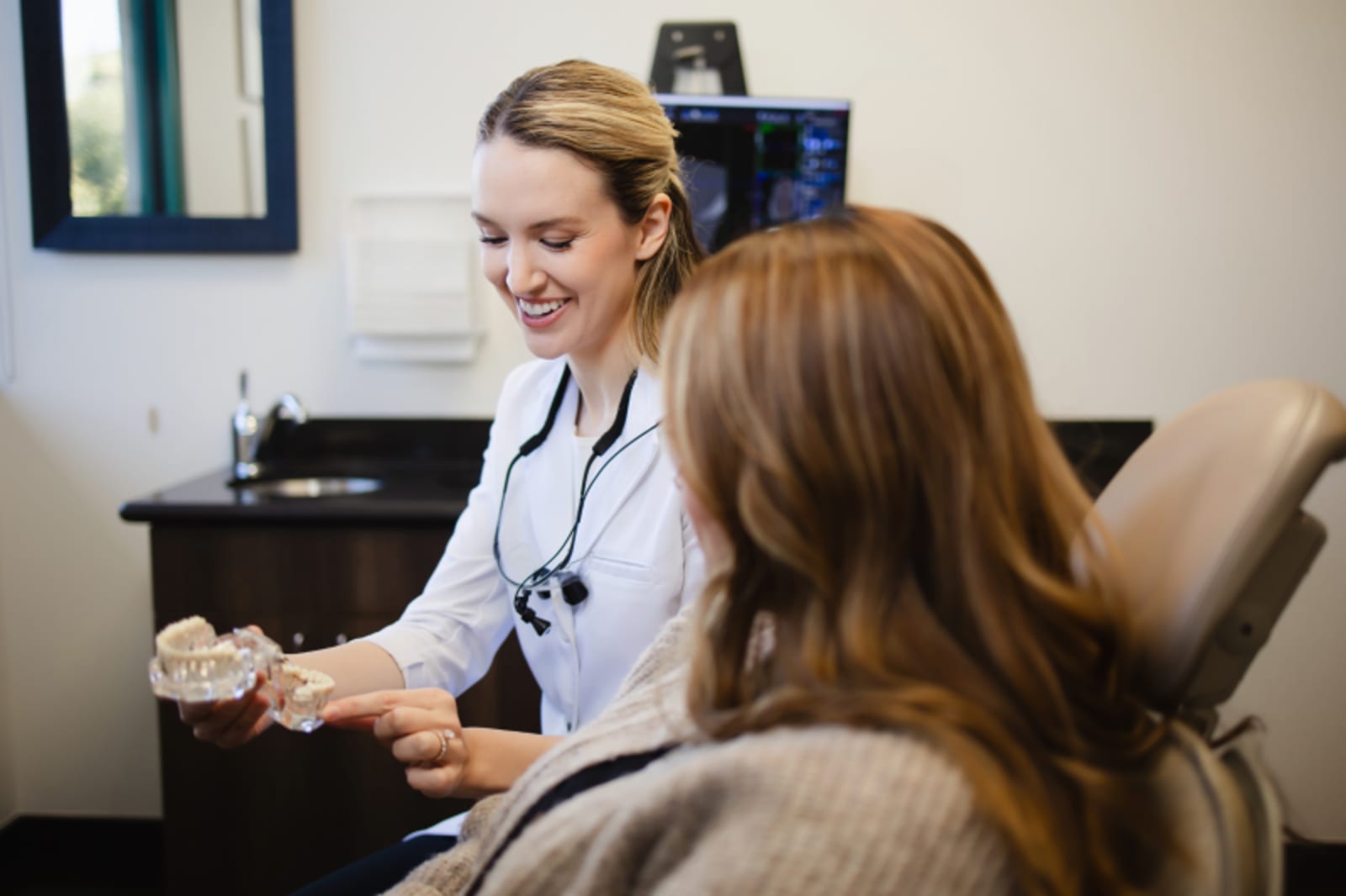 Dentist explaining dental procedure to patient during consultation