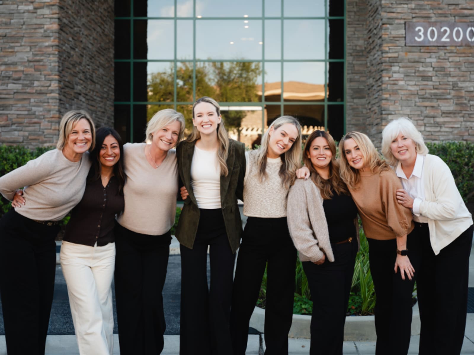 Restore Dental Studio team posing together at office entrance
