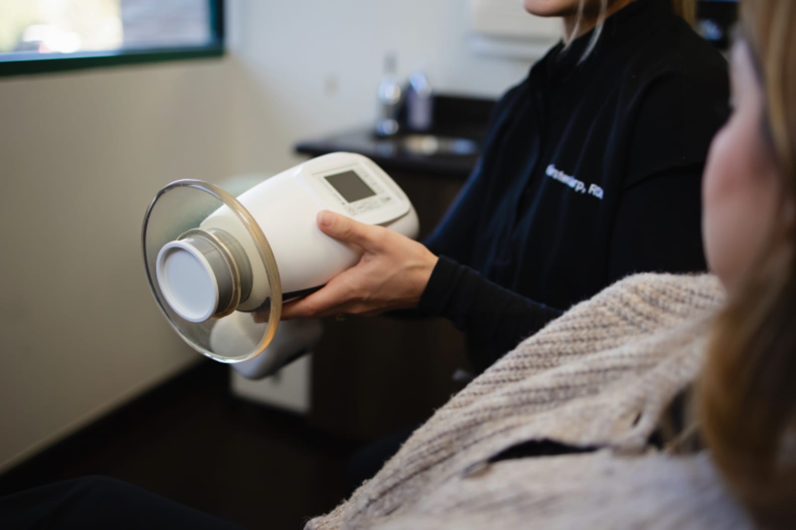 Dentist holding a dental model showing tooth restoration options