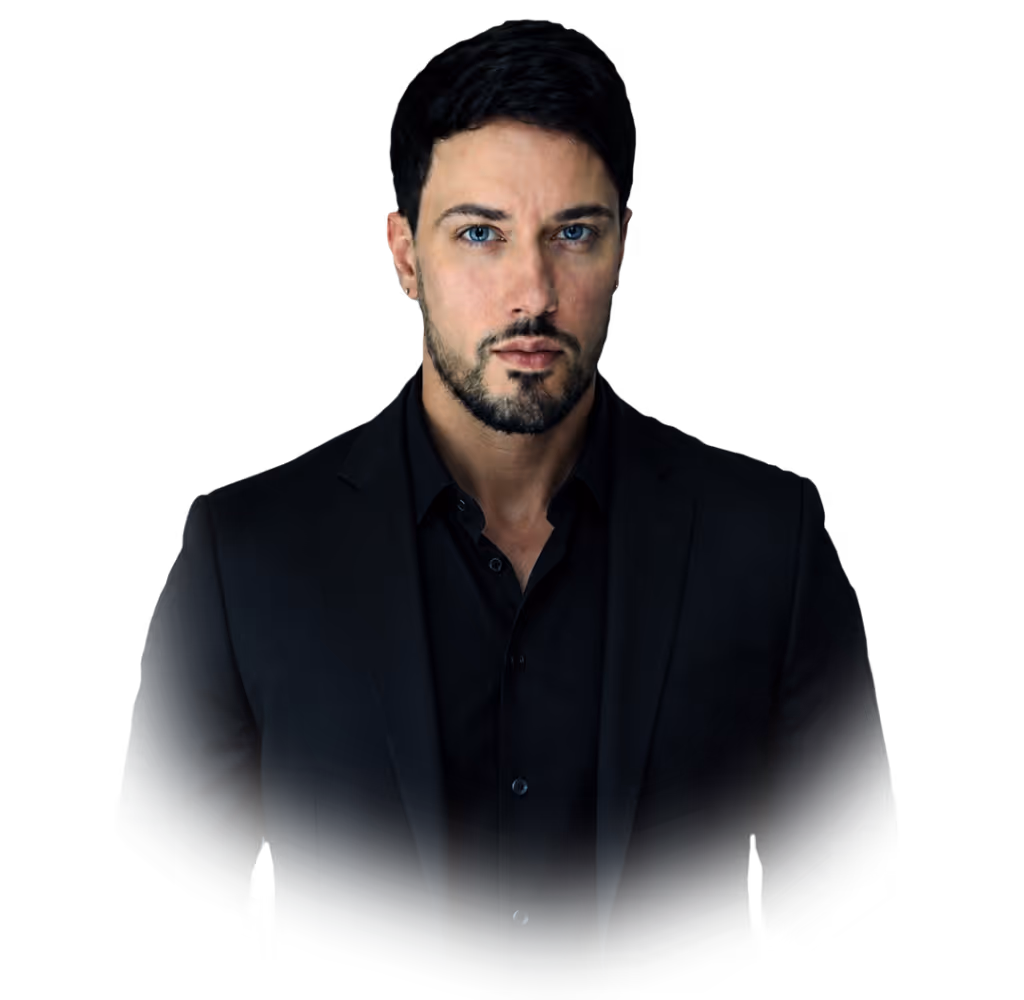 Portrait of a man with blue eyes wearing a black suit and shirt against a black background.
