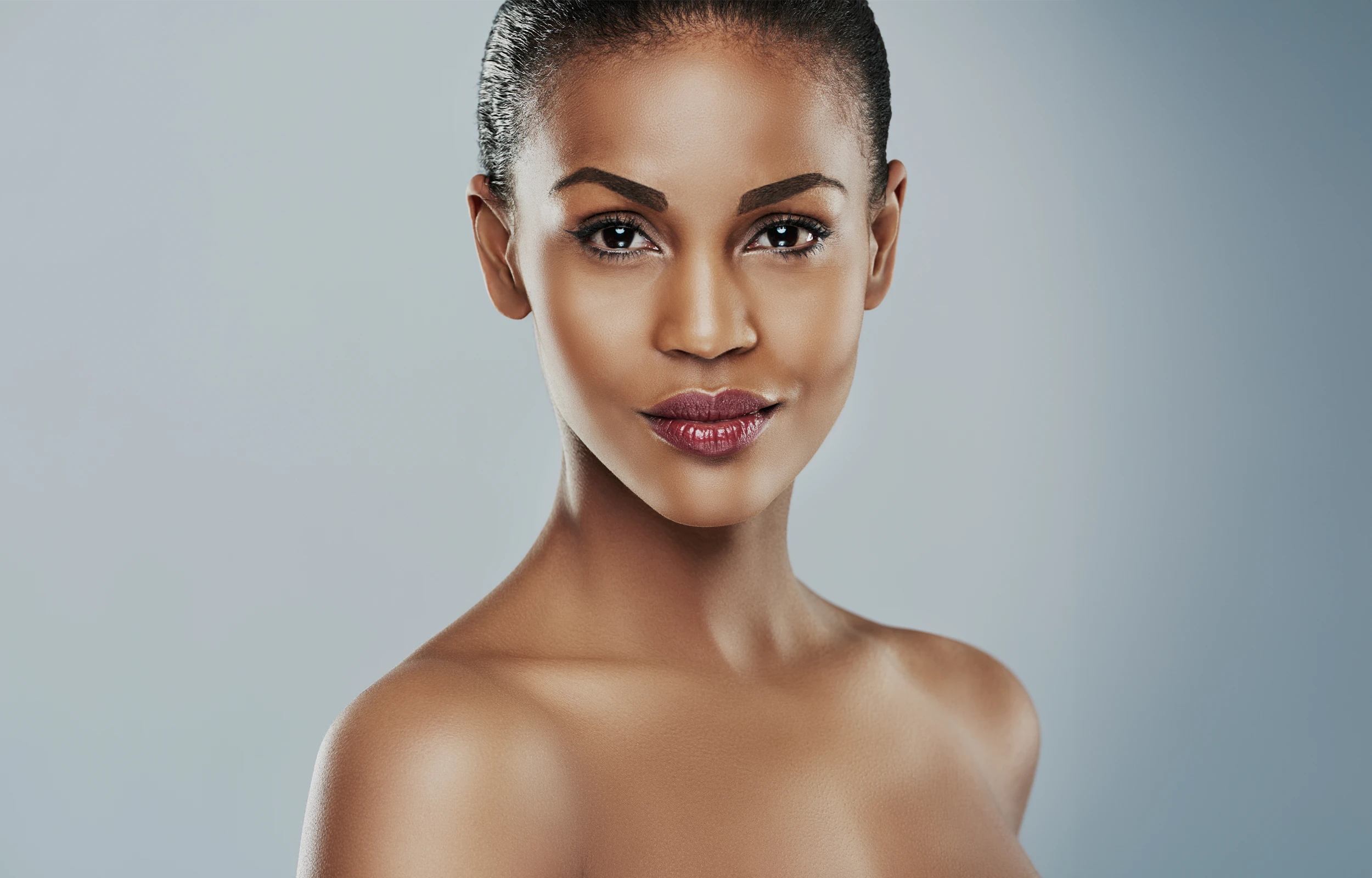 A woman with an afro is posing for a picture.