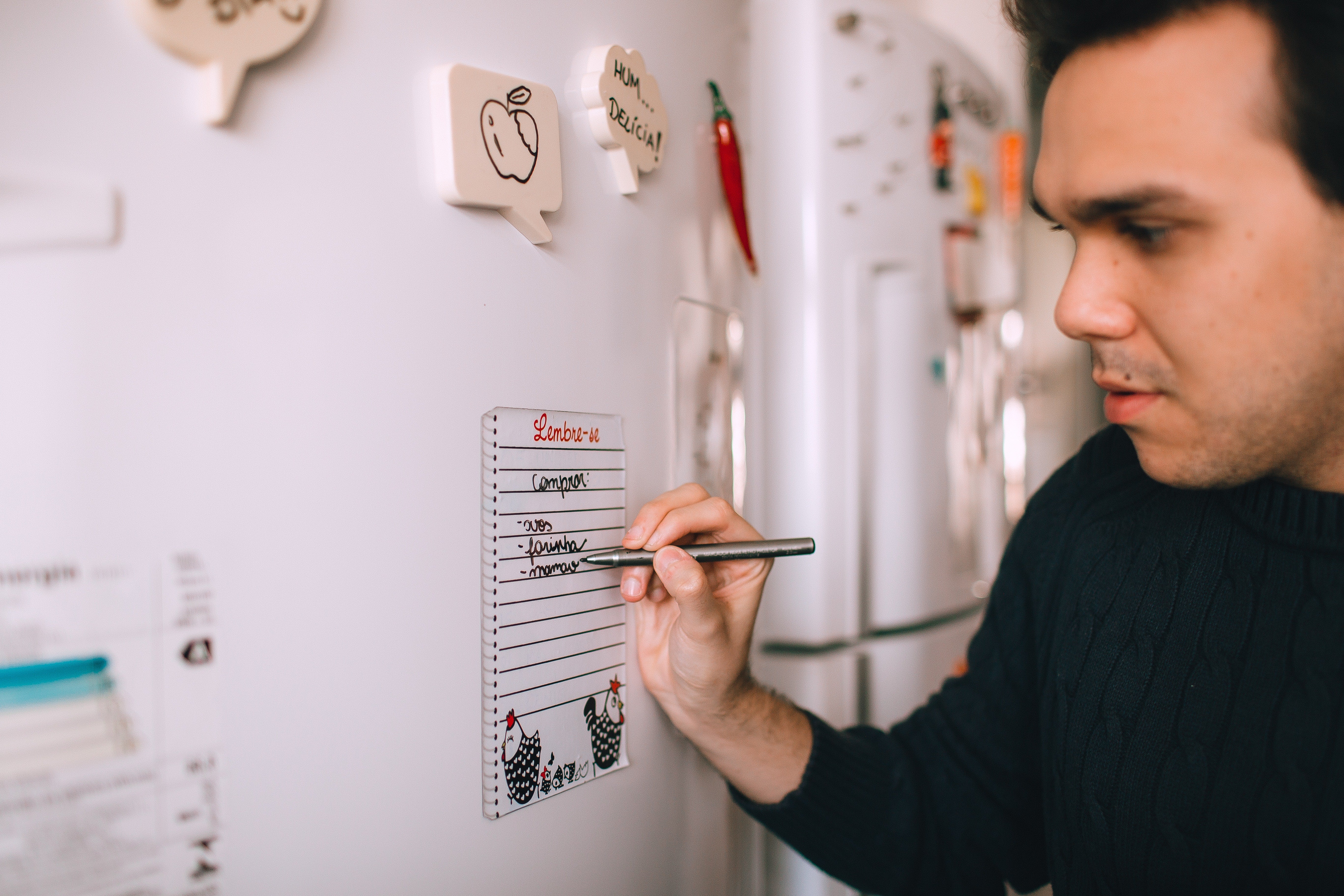 Image of person looking at checklist on fridges