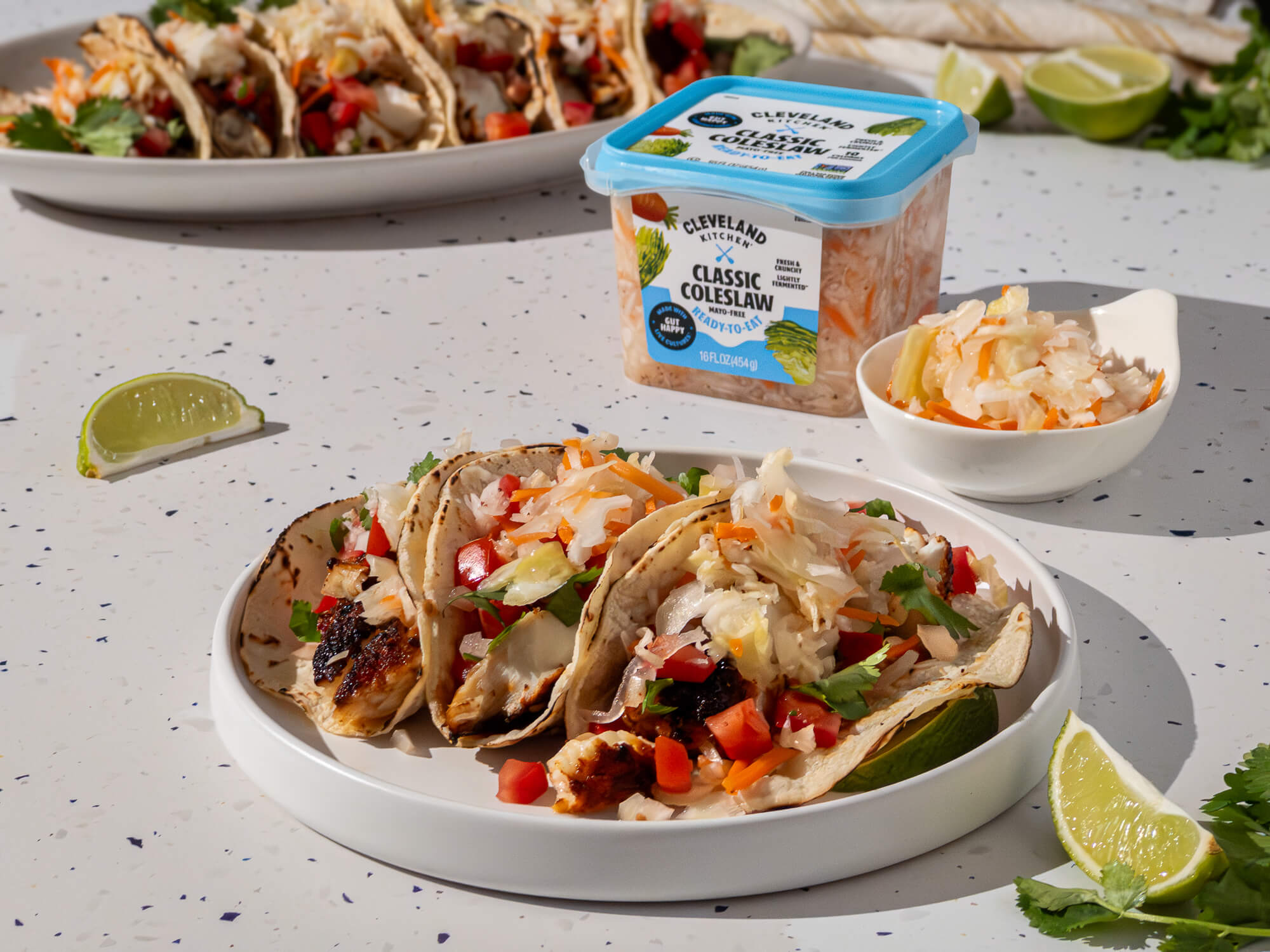 Fresh grilled fish tacos topped with mayo-free Classic Coleslaw from Cleveland Kitchen.