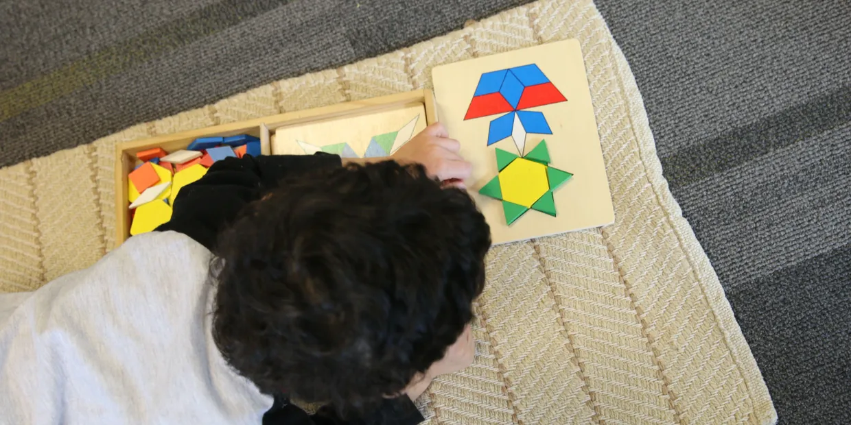 A boy playing with montessori toys in daycare