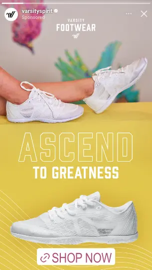 White varsity sneakers with a person wearing them against a colorful blurred background and text Ascend to Greatness, Shop Now button.