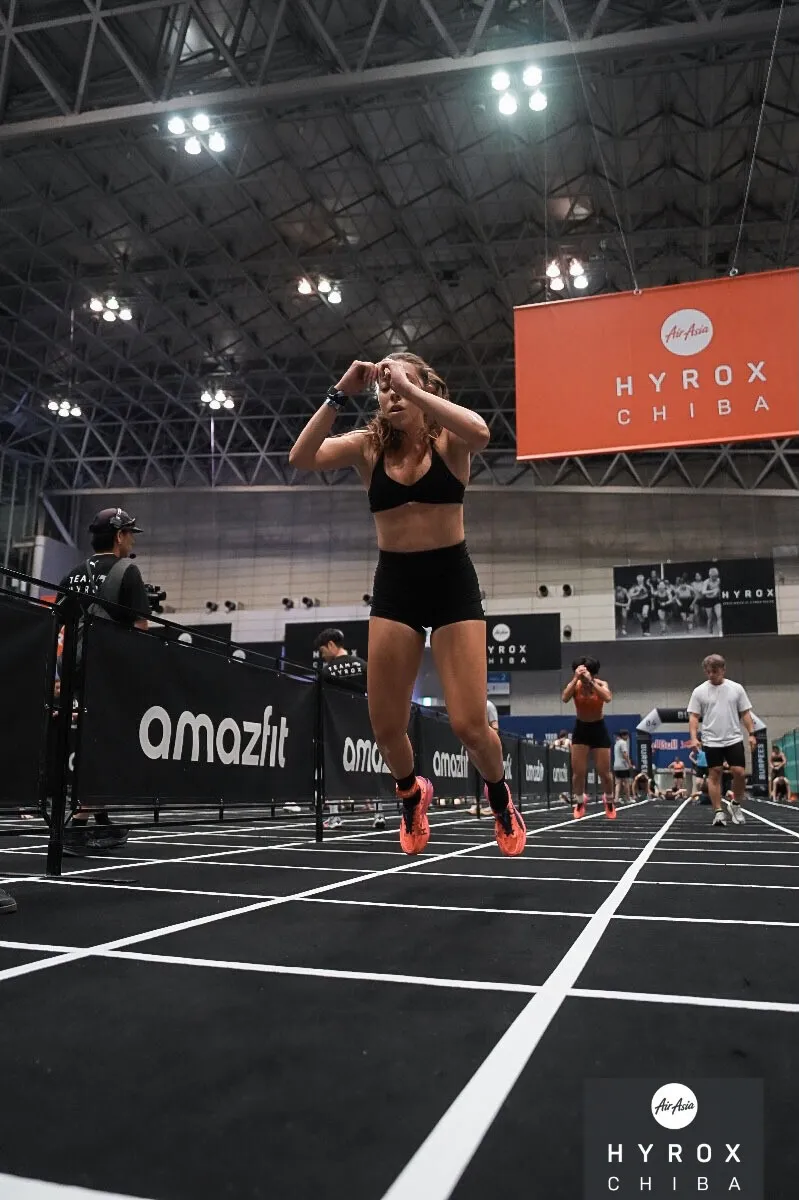 Chelsea Ribeiro doing burpee broad jumps during a HYROX race