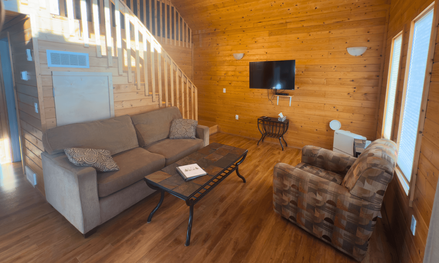 Wood-paneled cabin living area with large sofa