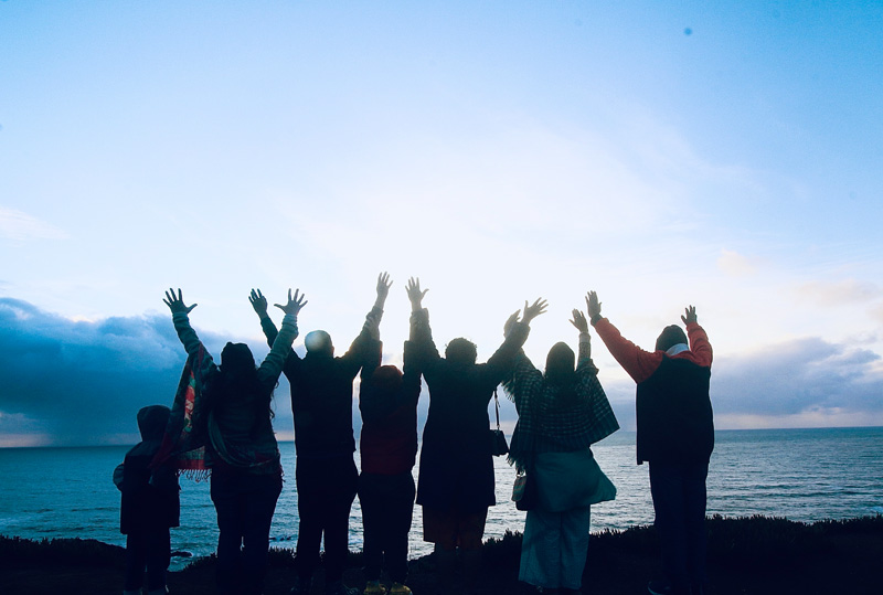 People with their hands folded over their Bibles at Dynamic Faith Ministries