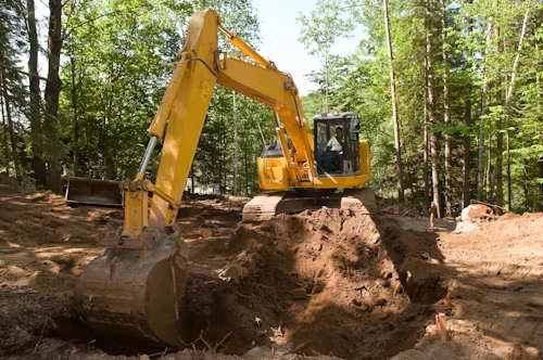 Mini excavator digging on a job site