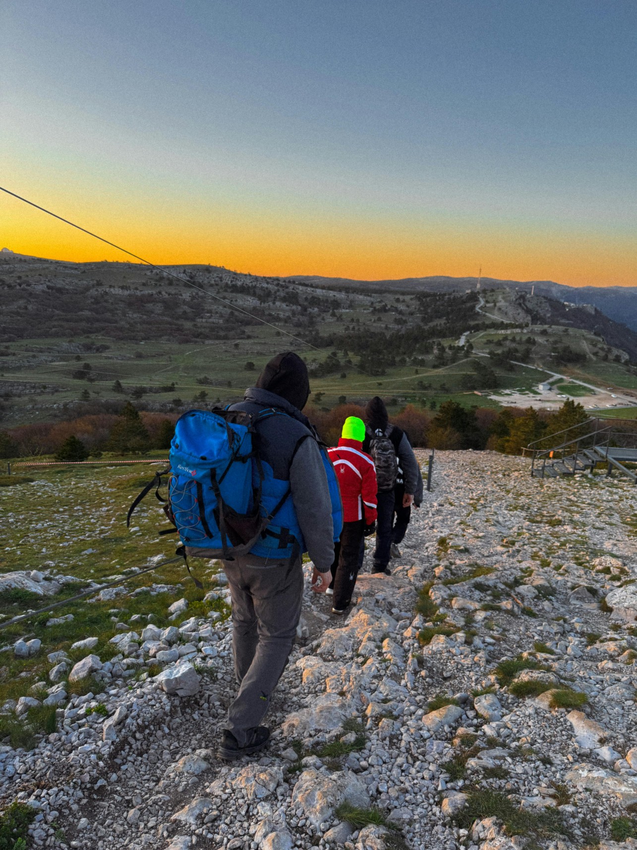 Traveller walking toward ancient cave dwellings carved into rocky hills