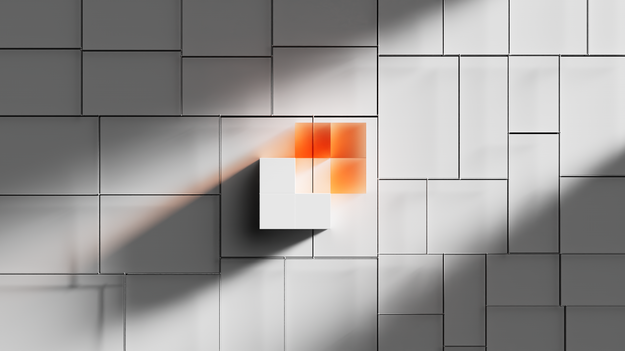 White and orange 3D cubes forming a pattern on a tiled gray surface with shadows.