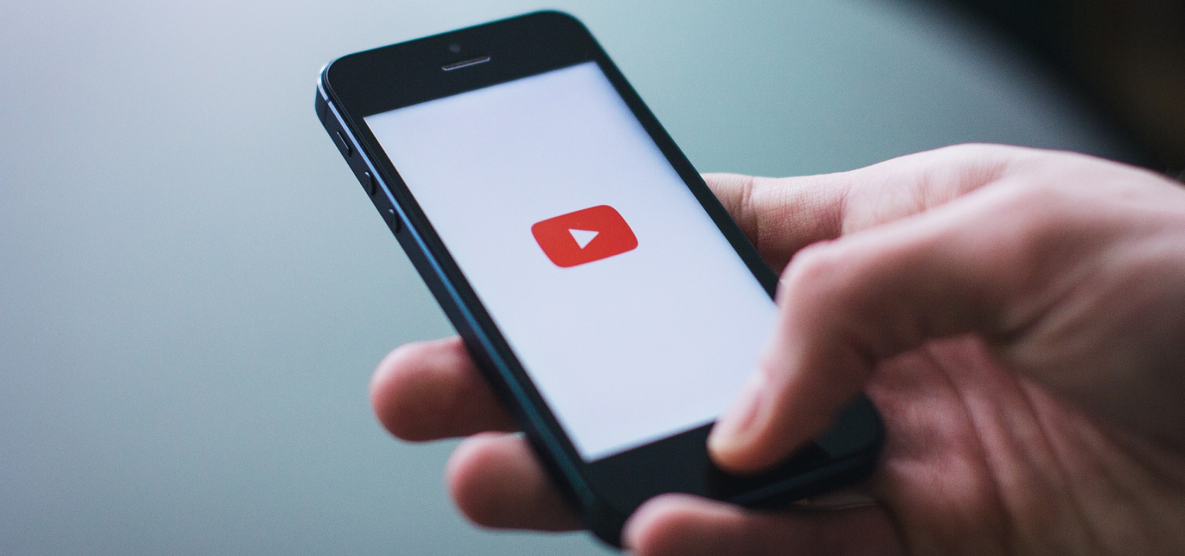 YouTube logotype on phone screen