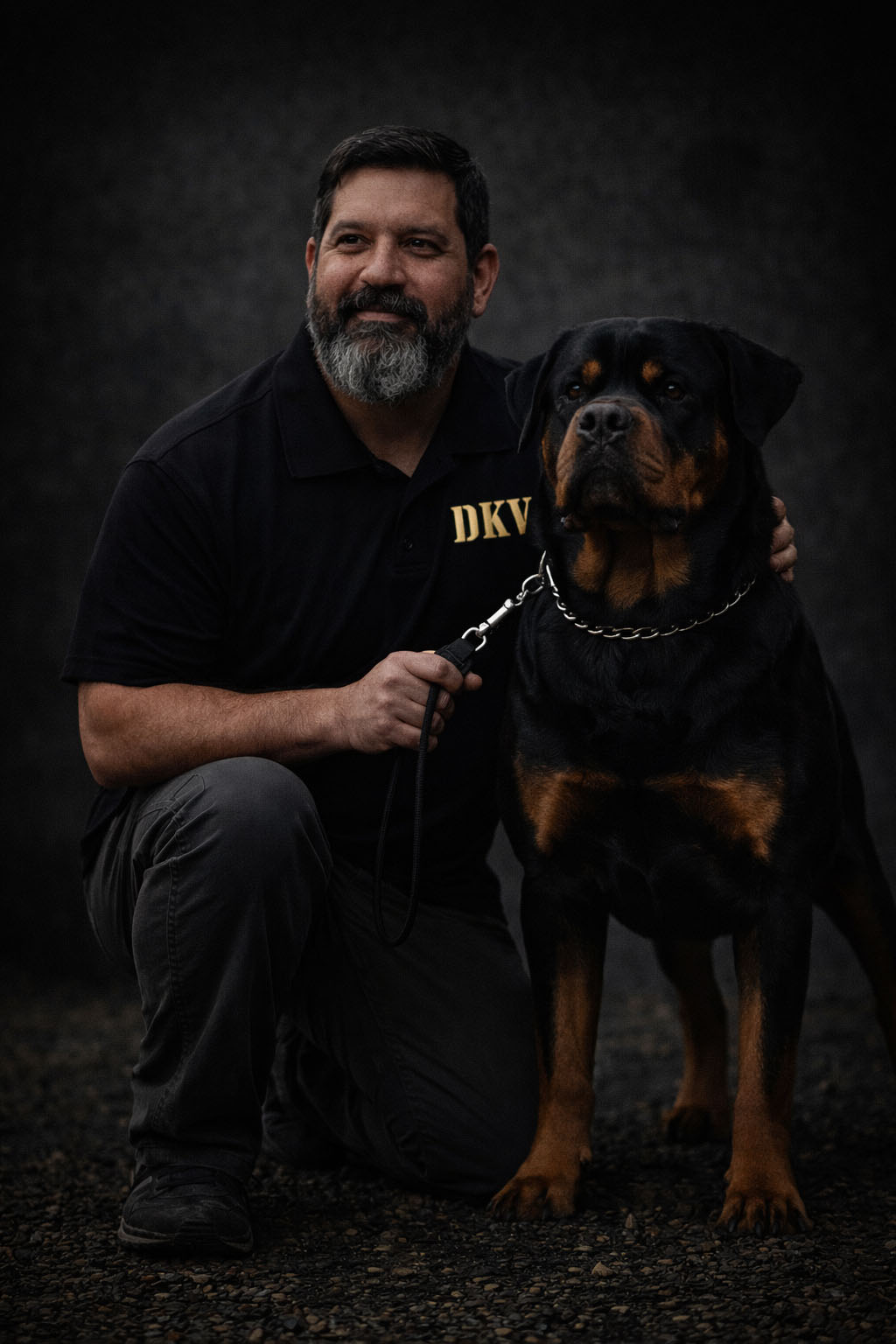 Angel Gutierrez of DKV Rottweilers with an adult male German Rottweiler stud, showcasing correct structure and breed type.