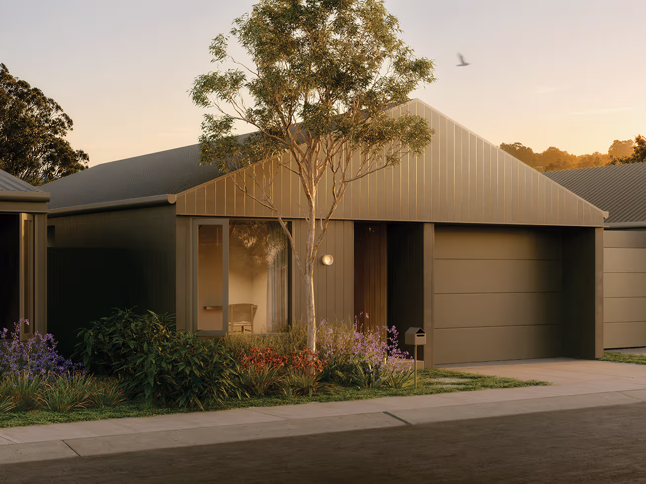 Modern house with a garage, reflecting windows, a tree, and landscaped garden in warm evening light.