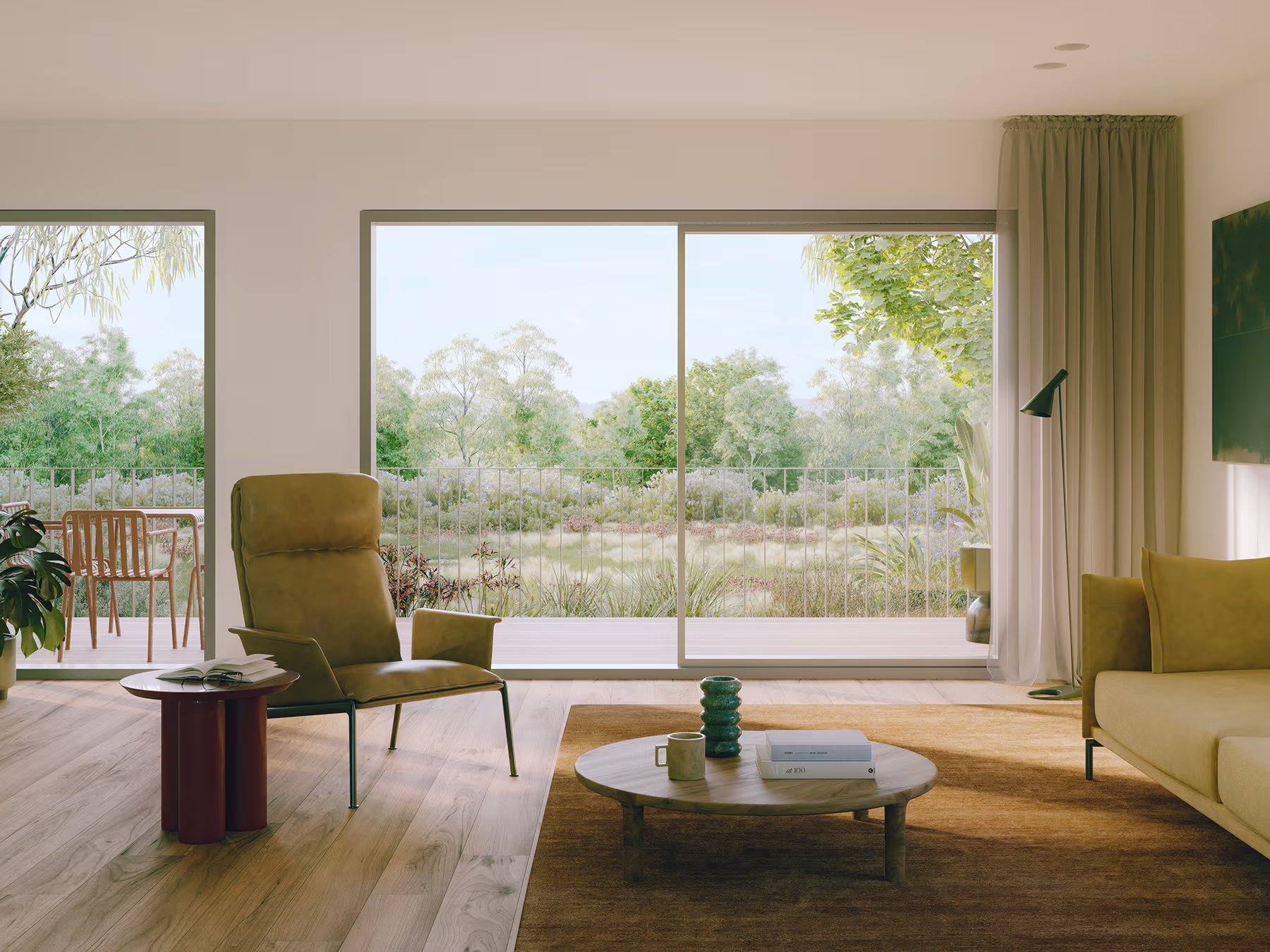 Modern living room with large sliding glass doors opening to a lush green outdoor view.