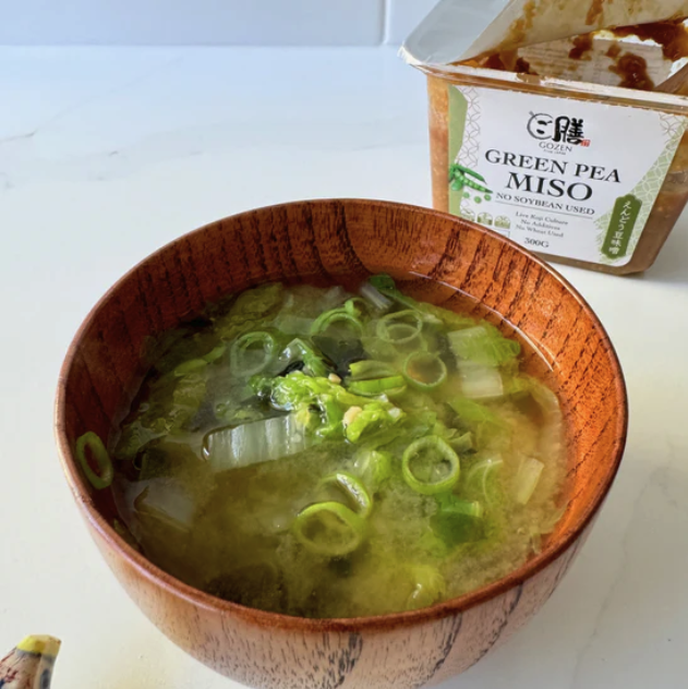Gozen Green Pea Miso container behimd a bowl fo Miso Soup