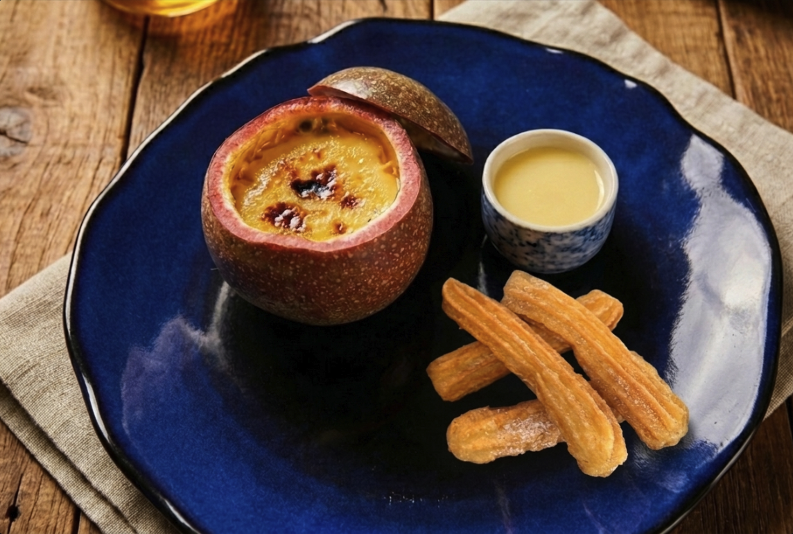 Plated Panama Passionfruit Brûlée with Churro Soldiers and whit chocolate sauce