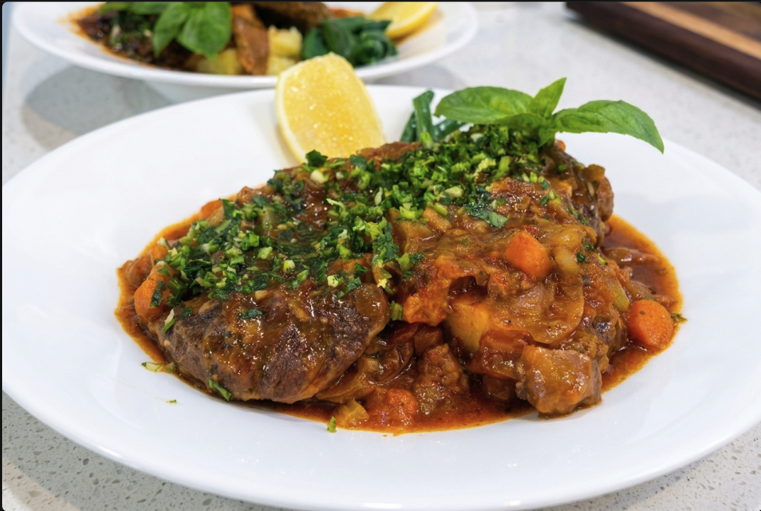 Bowl of Osso Buco in the Ninja 11-in-1 With Pomodoro, Veal Stock, Mash, Beans & Fresh Gremolata with a wedge of Lemon