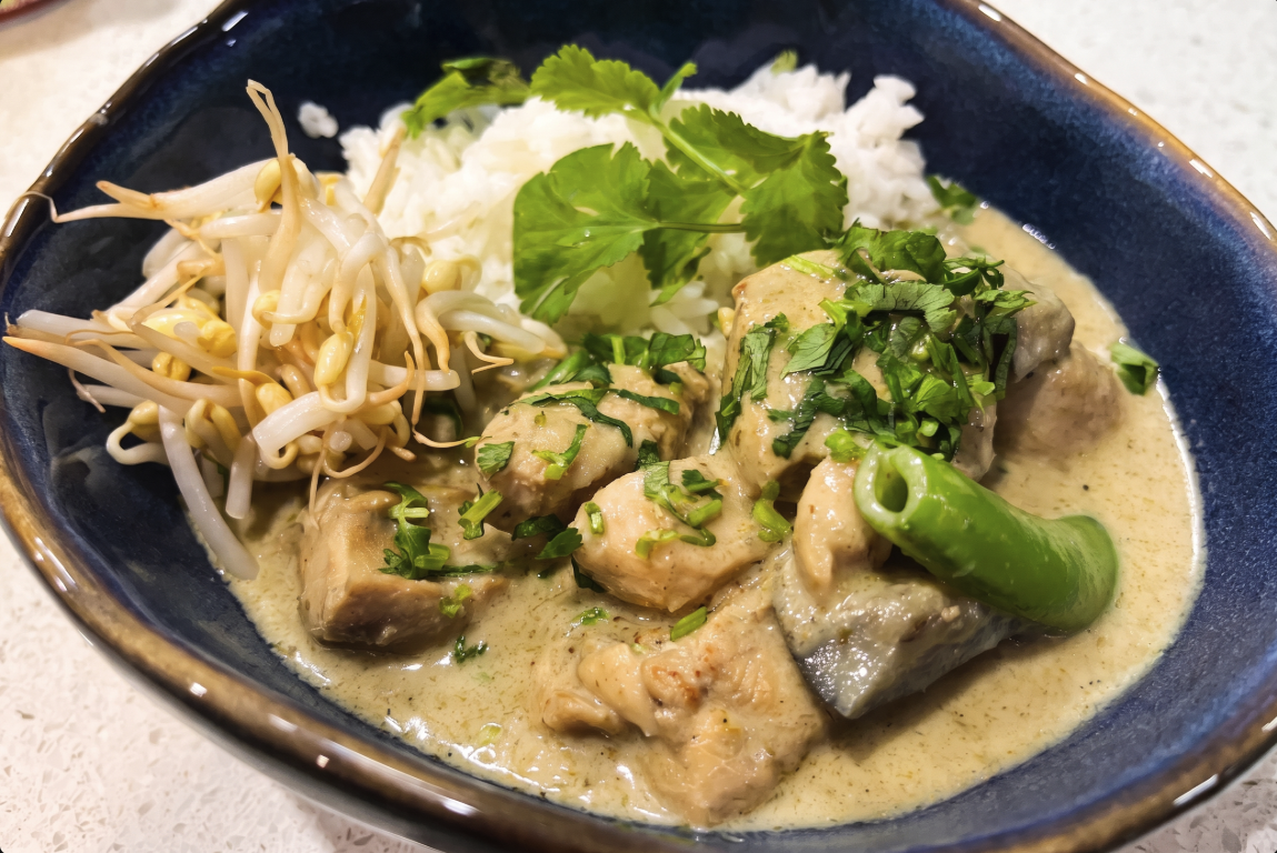 Bowl of Thai Green Chicken Curry with Jasmine Rice with a sprinkle of Coriander and garnised with Bean Sprouts