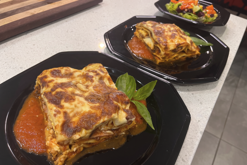 Plated Southern Italian Lasagne with Ham and Boiled Egg on napoli sauce with side salad