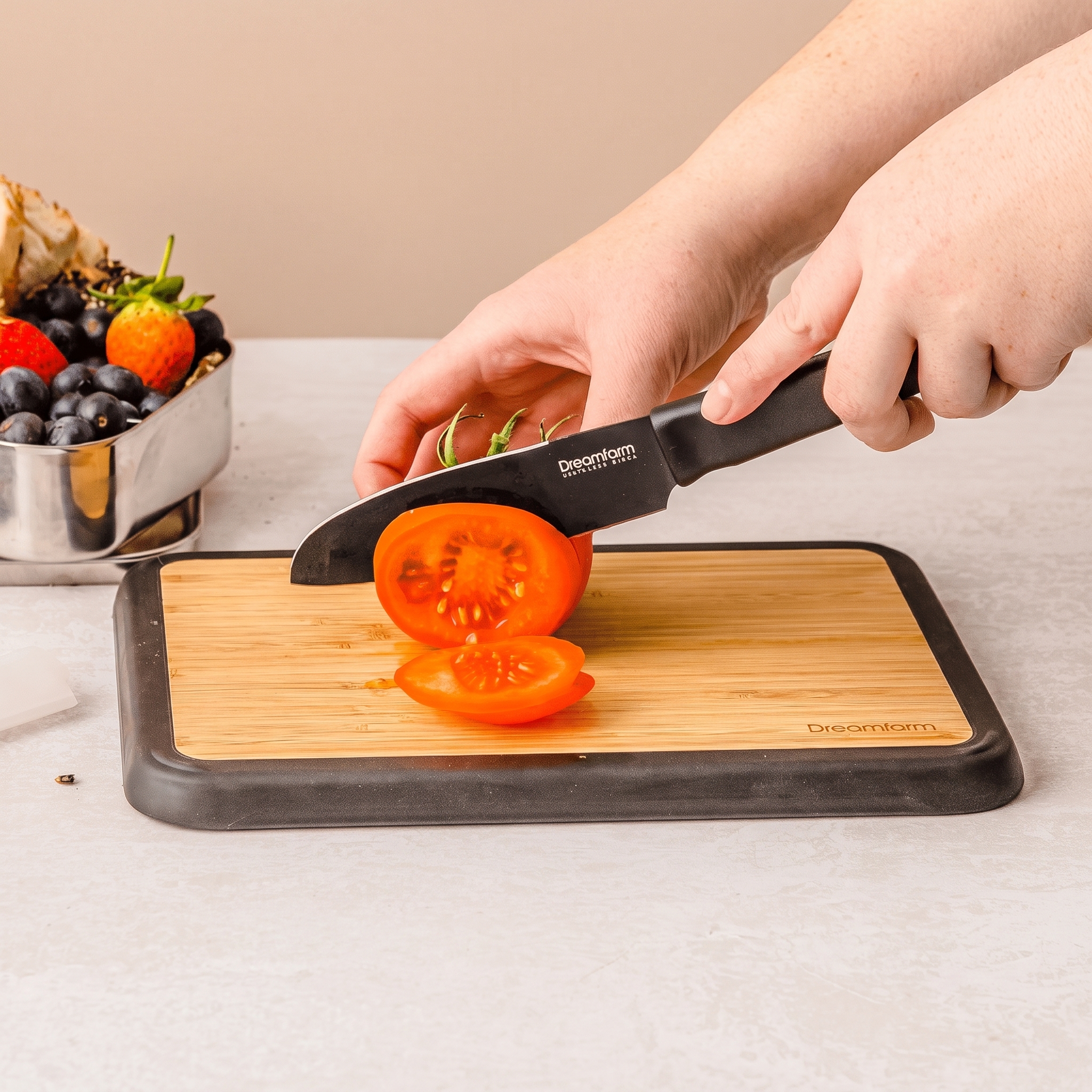 Dreamfarm Big Fledge Bamboo Cutting Board -flipped down to secure safe cutting surface for tomato slices