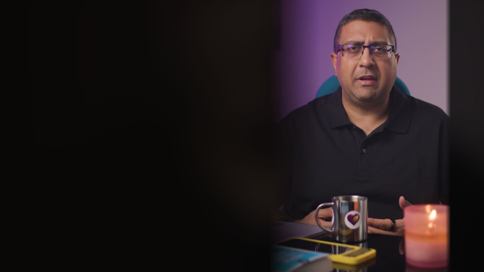 Paraag Amin at his desk by candlelight, the poster for his video