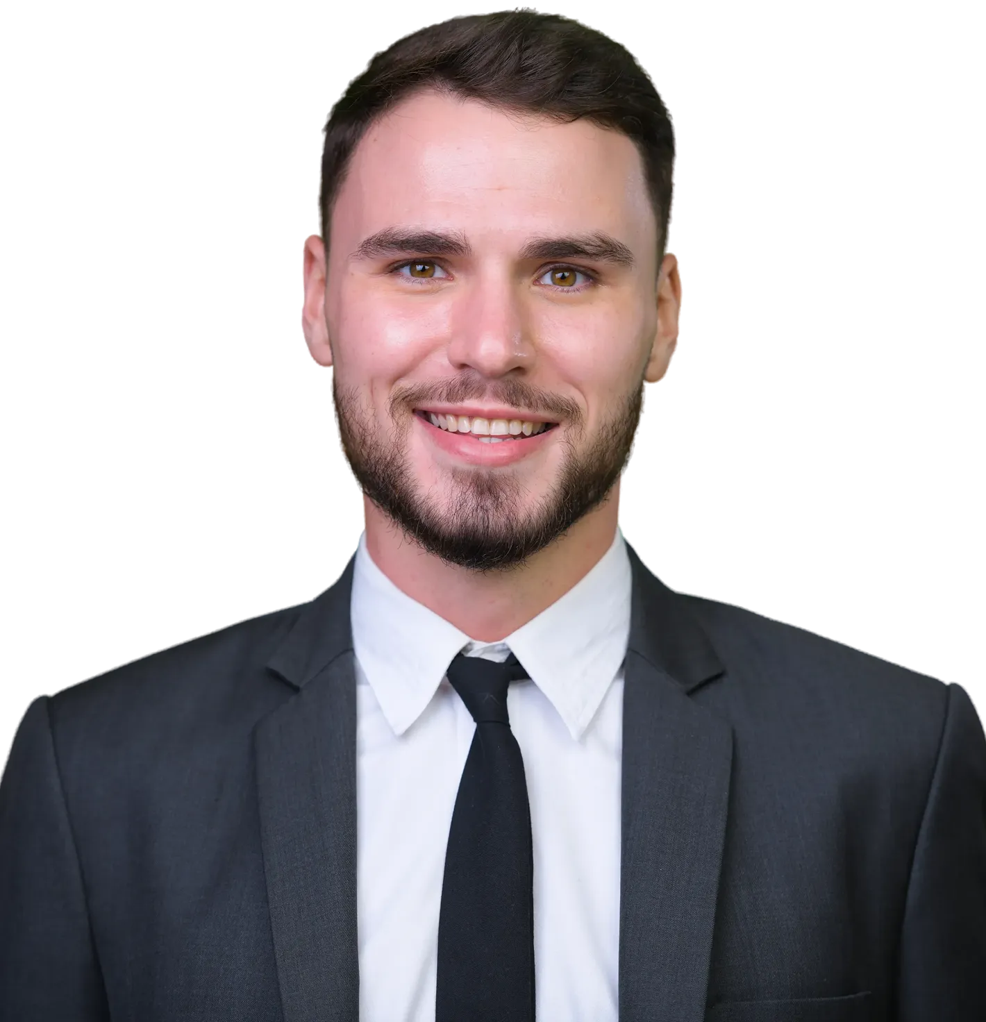 Smiling young man with short brown hair and beard, wearing a dark suit, white shirt, and black tie.