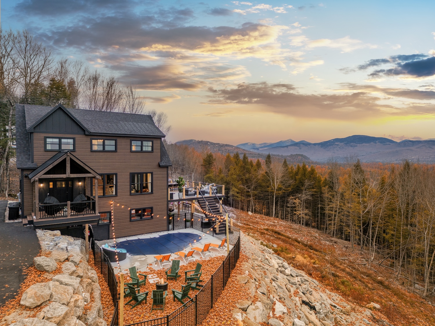 Mountain vacation home in Bethel, Maine with outdoor deck, seating area, and scenic fall foliage views