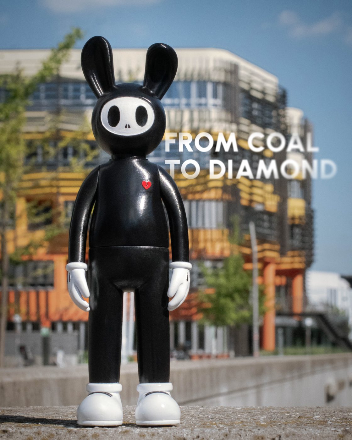 Coally in the street, FROM COAL TO DIAMOND on the building behind him.