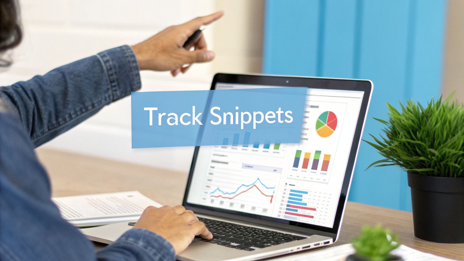 Person pointing and typing on a laptop showing data analytics charts with 'Track Snippets' overlay.