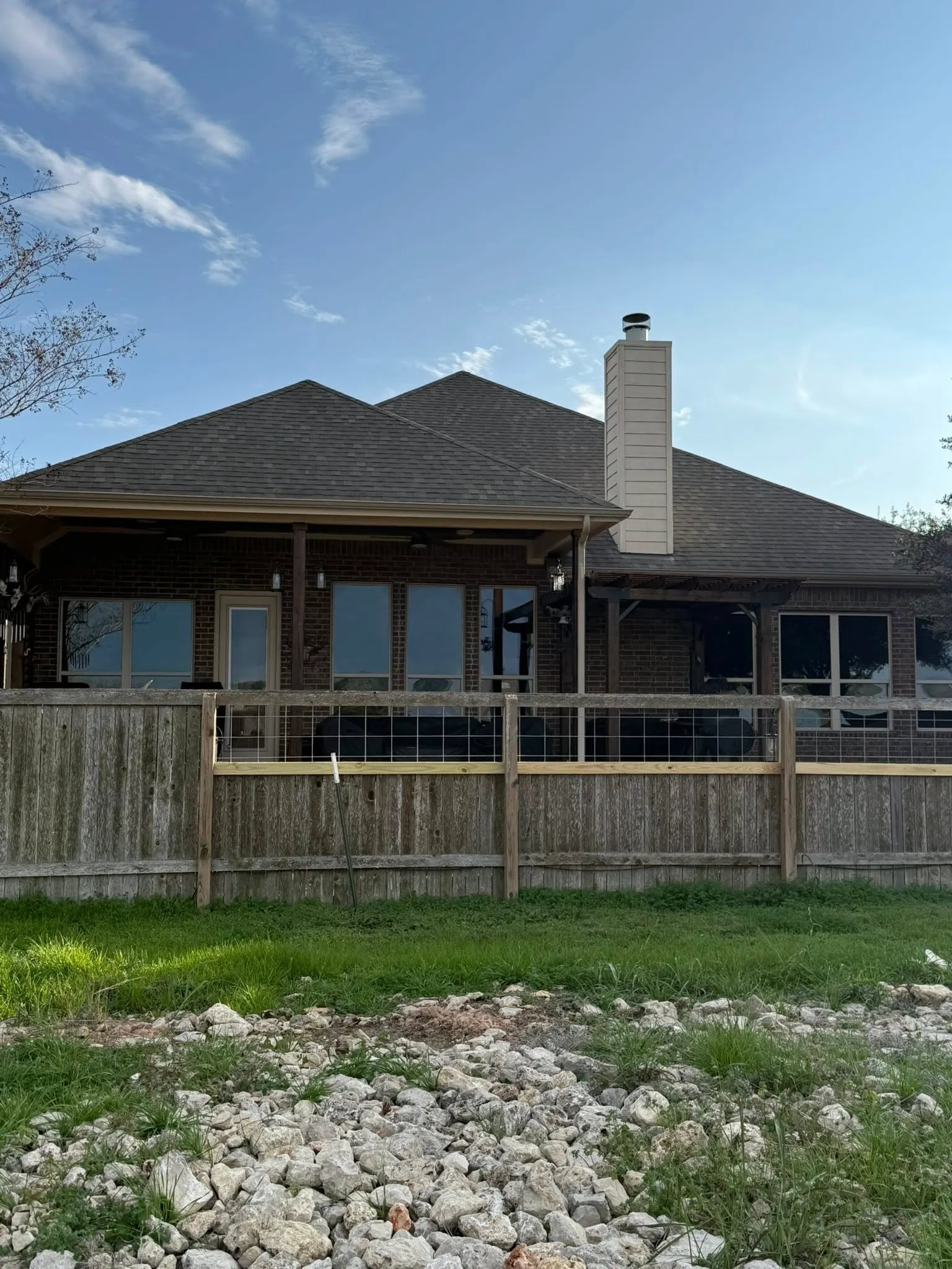 Back view of a brick house with freshly tinted windows.