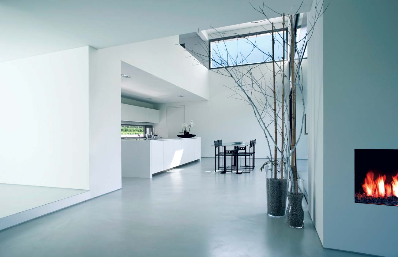 An image of a beautiful architectural home with a skylight, gas fire, and kitchen/dining