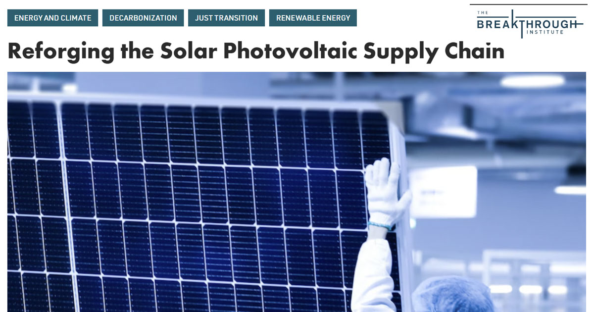 Worker wearing protective gloves handling a large solar photovoltaic panel inside an industrial facility.