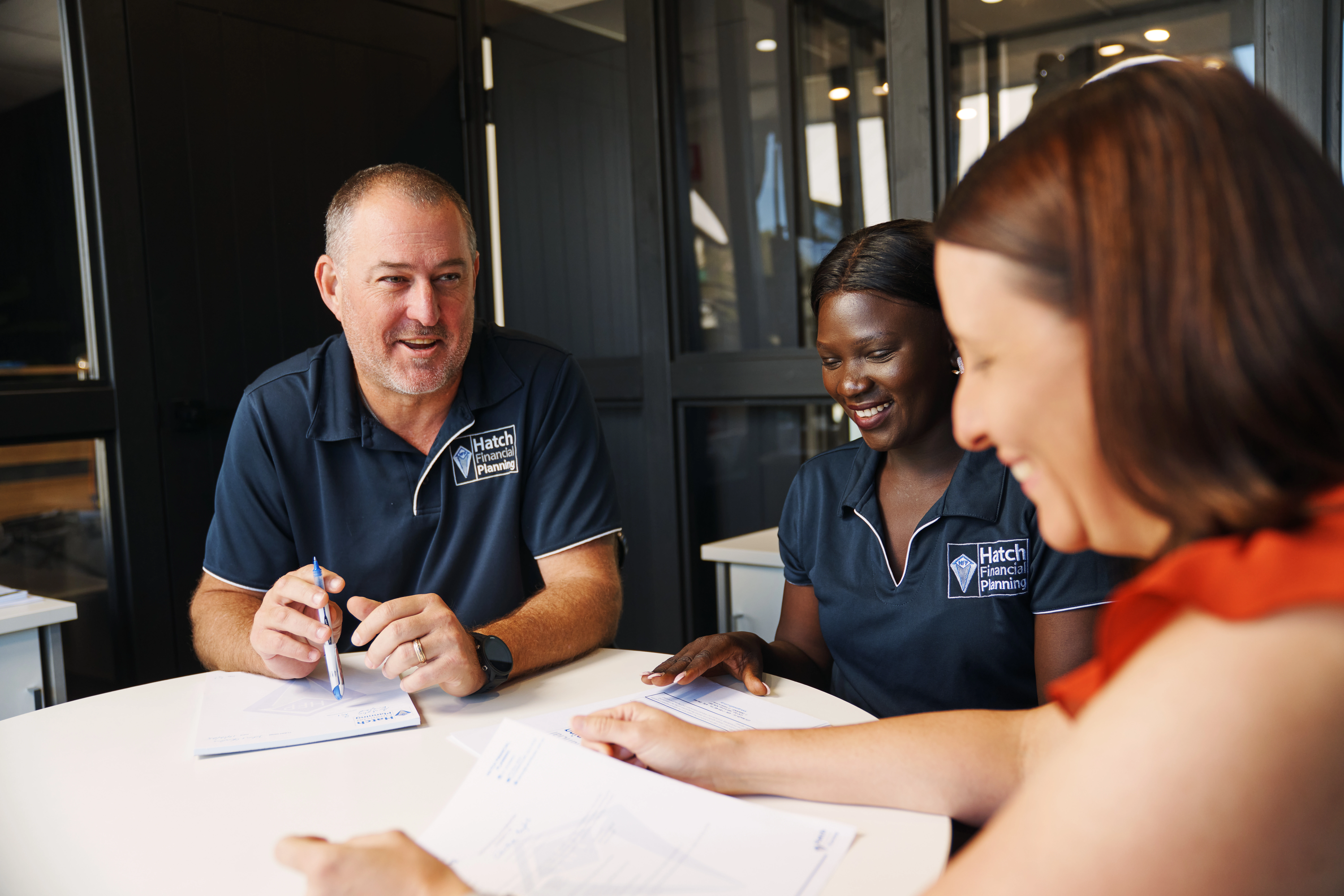 Two financial advisers meeting with a client