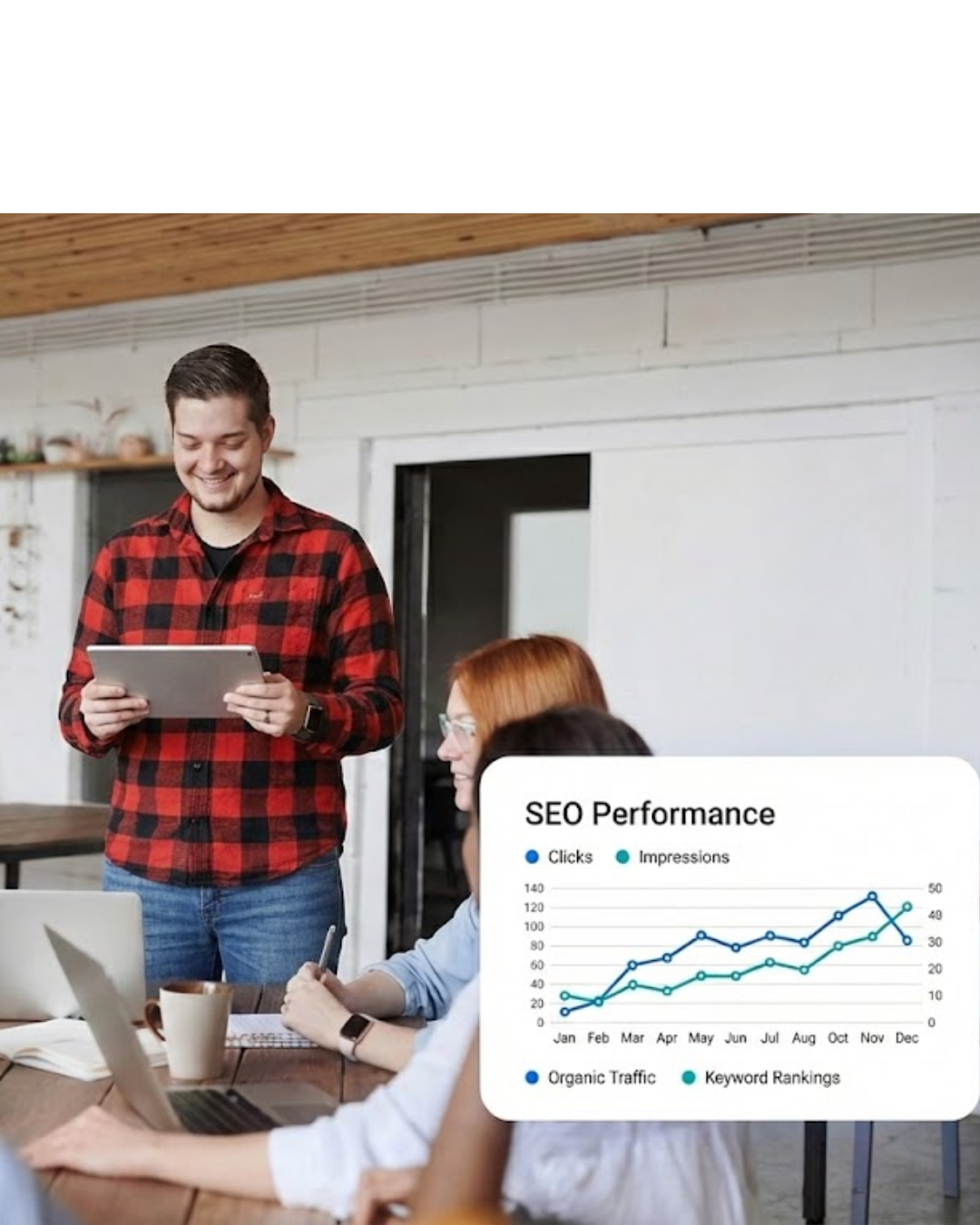 Man in red and black checkered shirt holding a tablet and smiling, with two people seated at a table using laptops, alongside an overlay graph showing SEO performance trends for clicks, impressions, organic traffic, and keyword rankings.