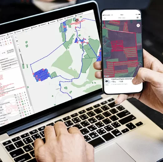 A person clicking on his laptop and phone screen.