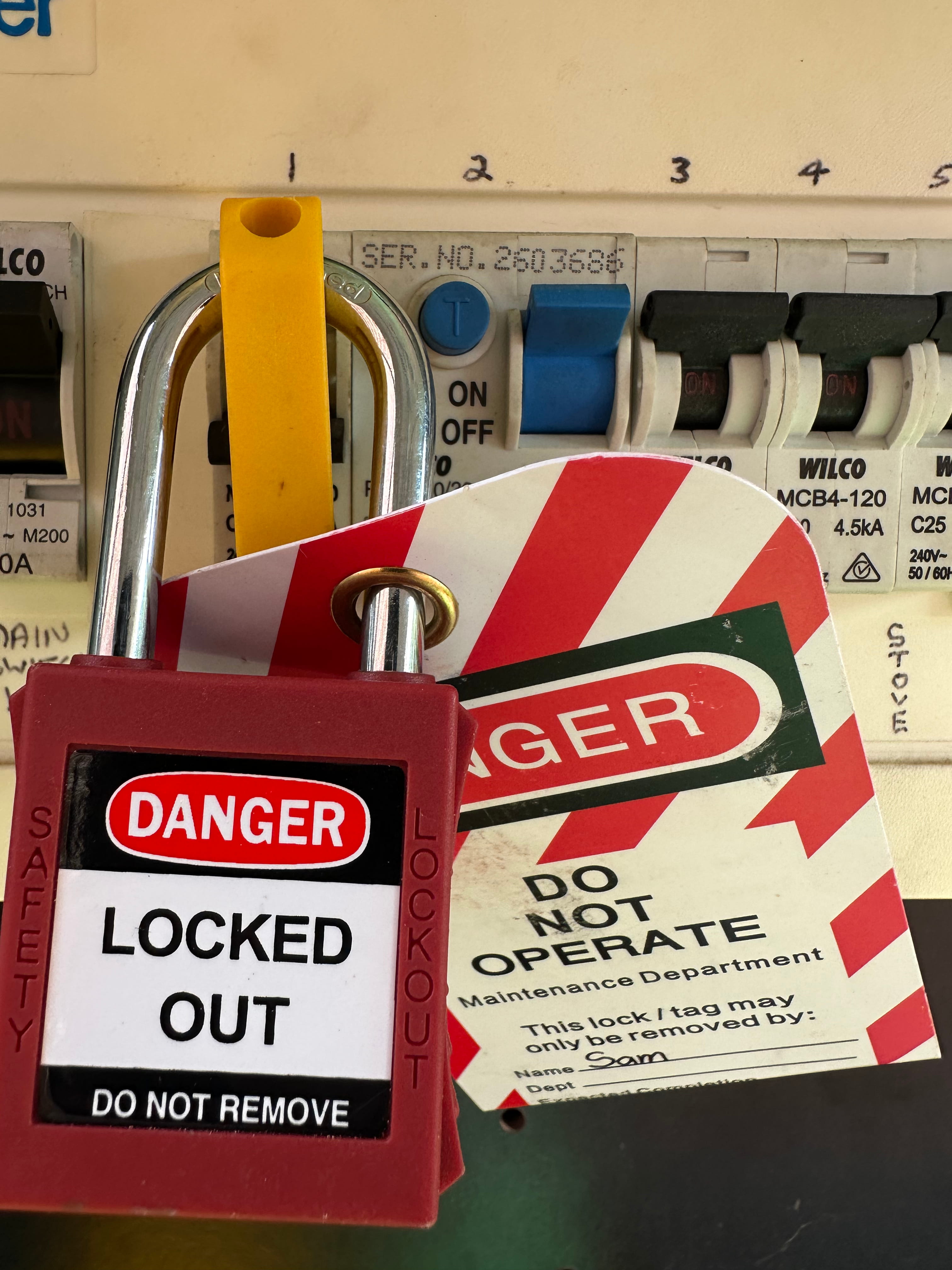 Electrical Level 2 Red lock with a 'Danger Locked Out Do Not Remove' tag securing an electrical panel switch.
