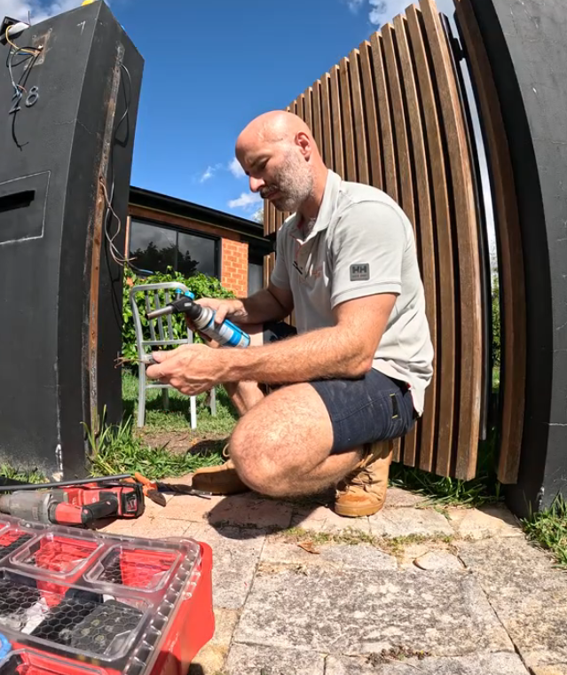 Electrical panel with a red lockout padlock labeled 'DANGER LOCKED OUT DO NOT REMOVE' and a danger 'DO NOT OPERATE' tag from the Maintenance Department.