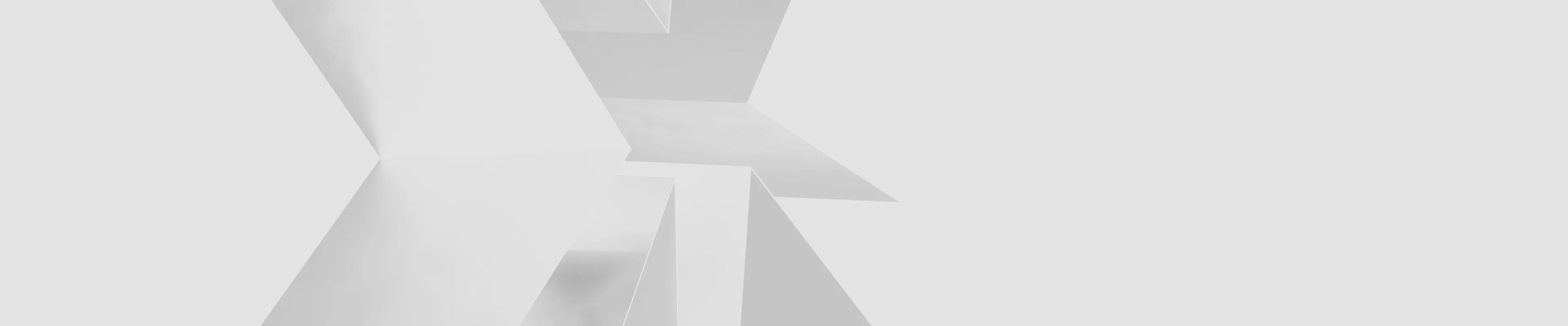 Abstract geometric 3D shapes with soft shadows in light gray tones.